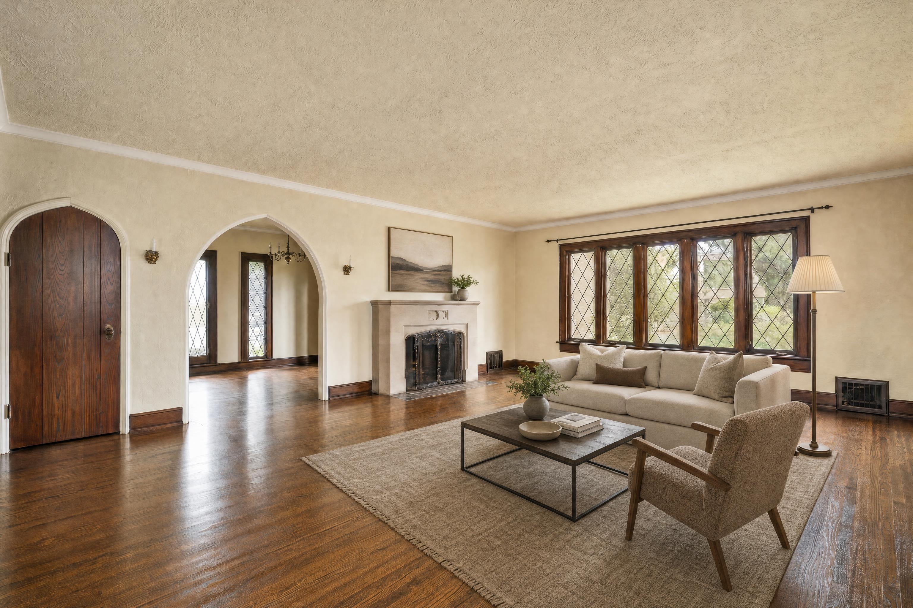 Living room in a 1930s Tudor house, virtually staged in a warm modern style